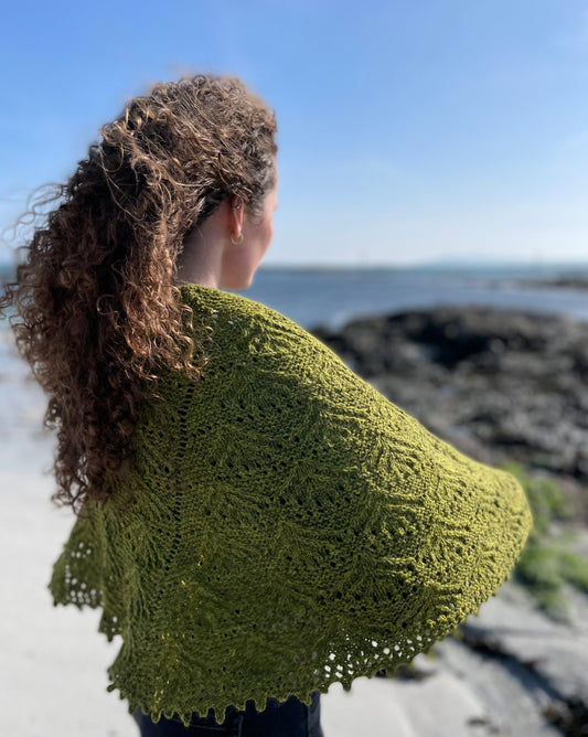 Beachcomber Shawl by Emma Vining. A green shawl, worn outside on the coast